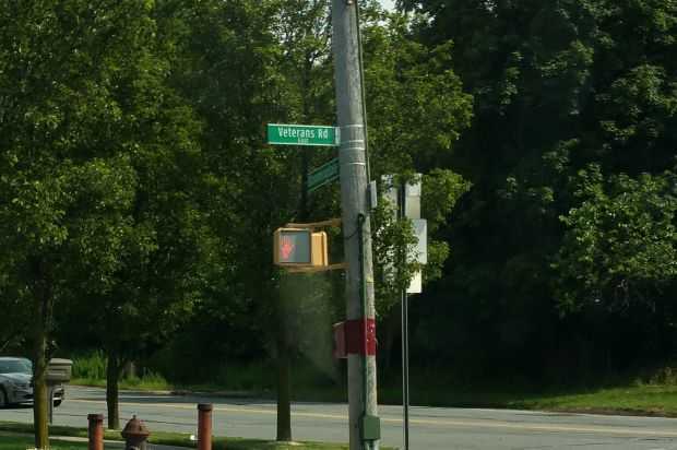 VETERANS ROAD EAST MEMORIAL STREET SIGN