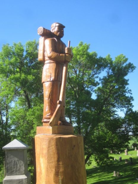 CHAIN SAW CARVING OF CIVIL WAR SOLDIER MEMORIAL