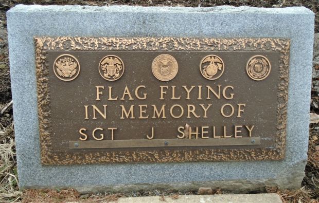 FLAG FLYING IN MEMORY OF SGT J SHELLEY MEMORIAL PLAQUE