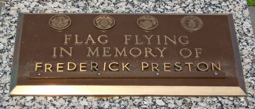 FLAG FLYING IN MEMORY OF FREDERICK PRESTON MEMORIAL PLAQUE