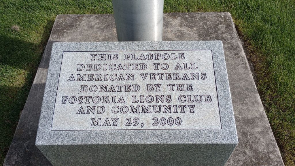 FOSTORIA LIONS CLUB VETERANS MEMORIAL FLAGPOLE STONE
