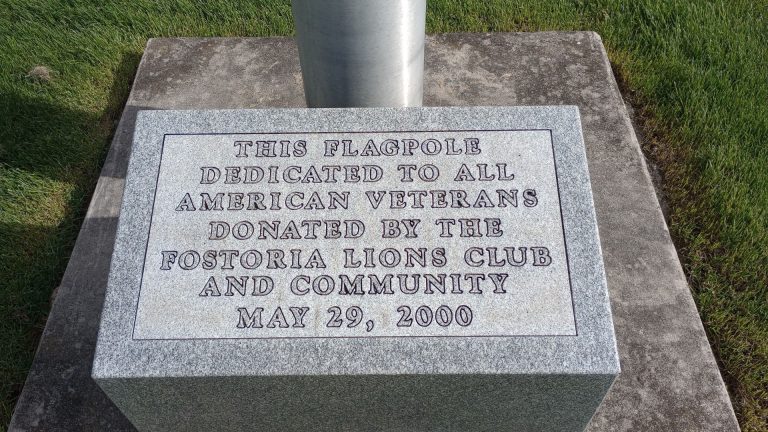 FOSTORIA LIONS CLUB VETERANS MEMORIAL FLAGPOLE STONE