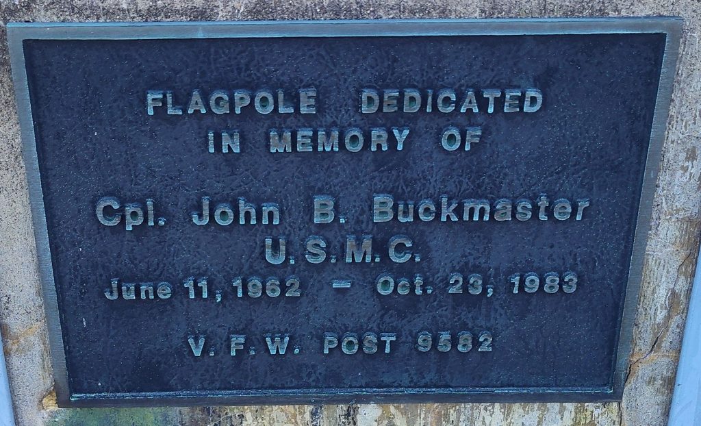 CPL. JOHN B. BUCKMASTER MEMORIAL FLAGPOLE PLAQUE