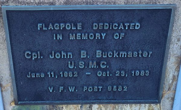 CPL. JOHN B. BUCKMASTER MEMORIAL FLAGPOLE PLAQUE