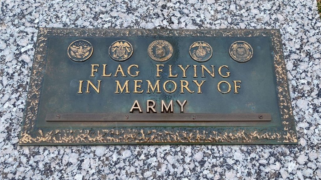 FLAG FLYING IN MEMORY OF ARMY MEMORIAL PLAQUE