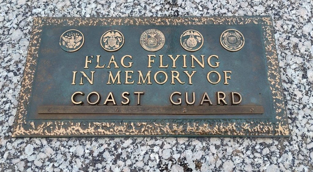 FLAG FLYING IN MEMORY OF COAST GUARD MEMORIAL PLAQUE