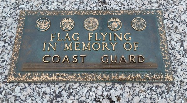 FLAG FLYING IN MEMORY OF COAST GUARD MEMORIAL PLAQUE