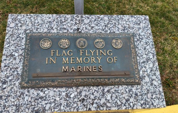 FLAG FLYING IN MEMORY OF MARINES MEMORIAL PLAQUE