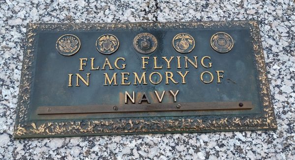 FLAG FLYING IN MEMORY OF NAVY MEMORIAL PLAQUE