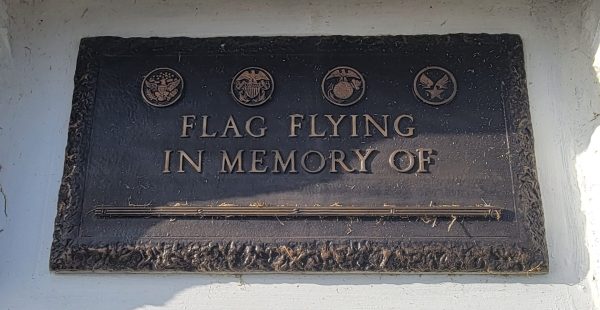 FLAG FLYING IN MEMORY OF ARMED FORCES MEMORIAL PLAQUE